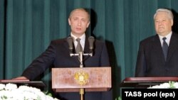 Владимир Путин присягает на Конституции во время инаугурации, 2000 г.