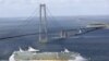 Denmark -- The Royal Caribbean's new cruise ship "Liberty of the Seas" sails under the Storebelt bridge in Denmark on her maiden voyage to Southampton, undated